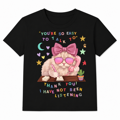 Black t-shirt with a cat graphic and humorous text on a white background