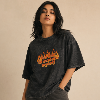 Person wearing a black t-shirt with flame graphics and text on a beige background